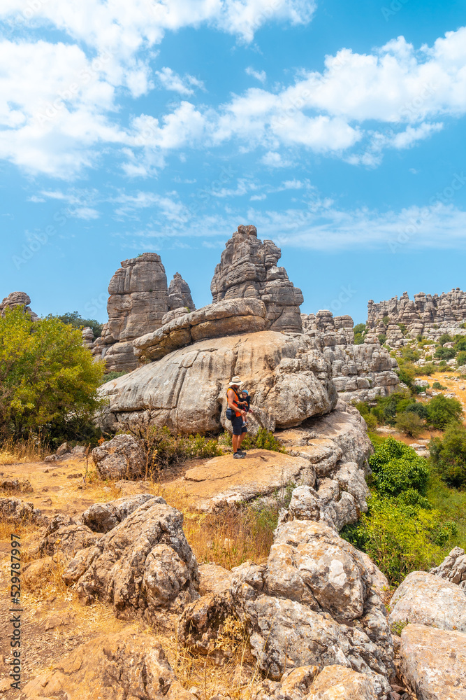 A young father with his son enjoying the Torcal de Antequera on the green and yellow trail, Malaga