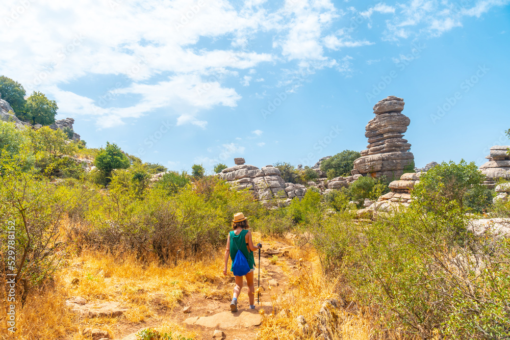 A young woman trekking in Torcal de Antequera on the green and yellow trail, Malaga A young woman trekking in Torcal de Antequera on the green and yellow trail, Malaga