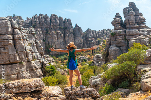 A young woman in Torcal de Antequera on the green and yellow trail enjoying freedom, Malaga