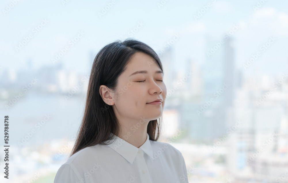 woman stands by the window