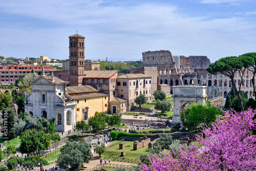 A beautiful view of Fori Imperiali, Fori Romani and Rome Coliseum on a sunny day.
