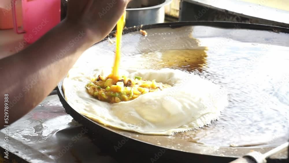 Footage of the process of making famous food from Indonesia which is usually called martabak. Martabak is a popular take away food among Indonesians, often served with pickled cucumber.