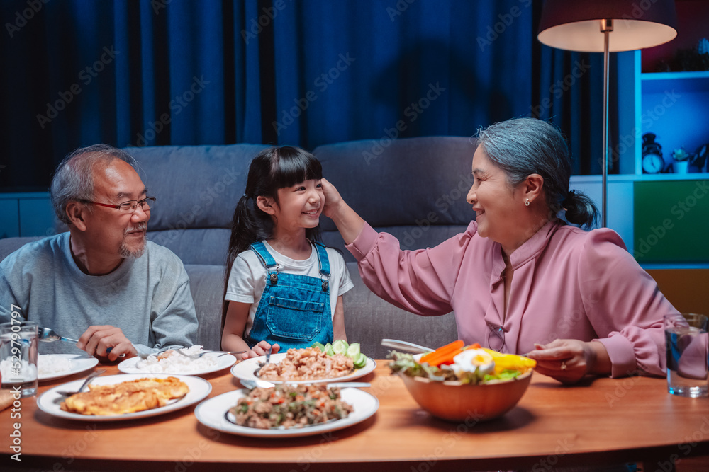 Asian happy family having lunch on dinner japanese table smiling together. little kid daughter enjoy eating food grandparents. Happiness time people lifestyle concept. Asian happy family having lunch on dinner japanese table smiling together. little kid daughter enjoy eating food grandparents. Happiness time people lifestyle concept.