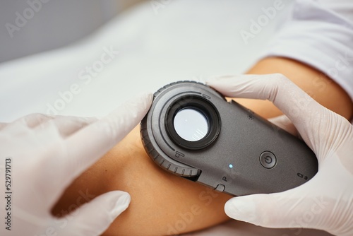 A dermatologist examines the skin.