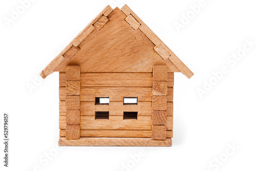 Small wooden toy house. Background for the construction of housing from natural, environmentally friendly materials.