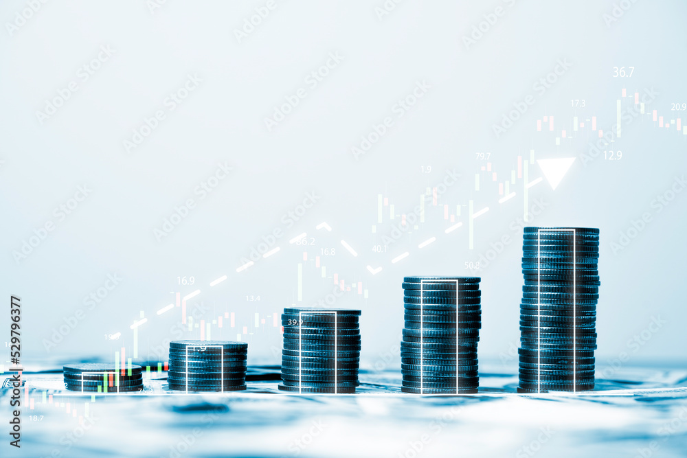 Fototapeta premium Coins stacking with increasing graph stock market graph chart for business investment and stock market analysis concept.