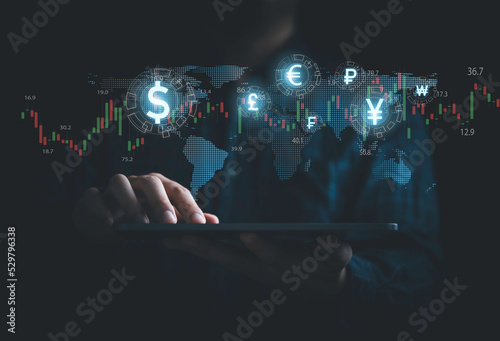 Print op canvas Global currency exchange and money transfer concept, Businessman using tablet with world map and currency sign include dollar yuan yen euro and pound sterling