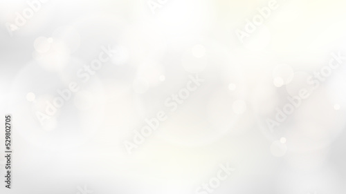 Abstract golden circles glow lights bokeh effect blurred white and grey background luxury style. Christmas winter festive backdrop