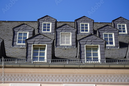 Similar roof bays with old slate cladding on gabled dormer windows in the old town, Plauen city, Vogtland district, Saxony, Germany.