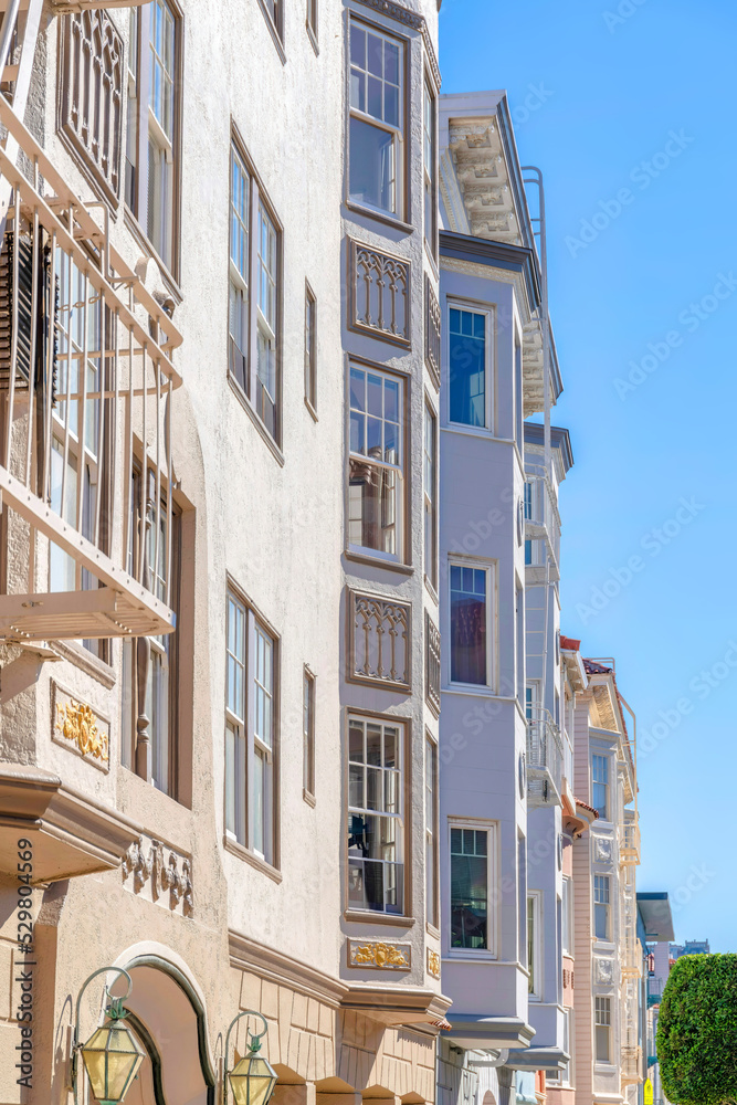 Row of apartments with painted stucco walls and victorian trims in San Francisco, CA Row of apartments with painted stucco walls and victorian trims in San Francisco, CA