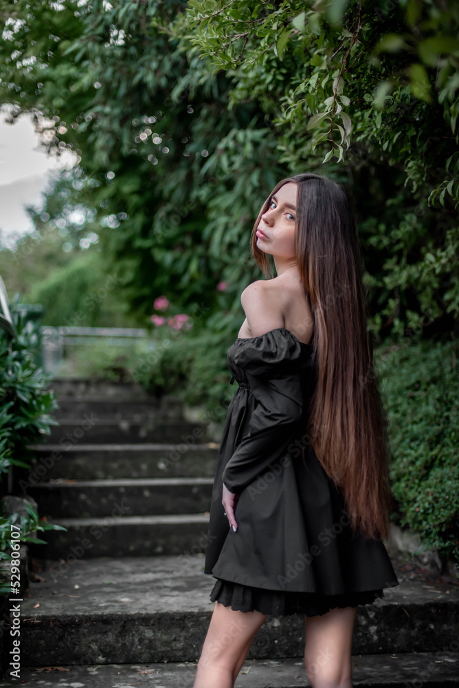 portrait of a beautiful girl on the stairs in the park portrait of a beautiful girl on the stairs in the park