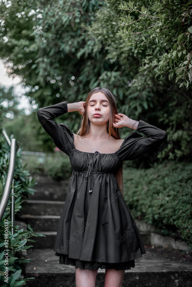 portrait of a beautiful girl on the stairs in the park portrait of a beautiful girl on the stairs in the park