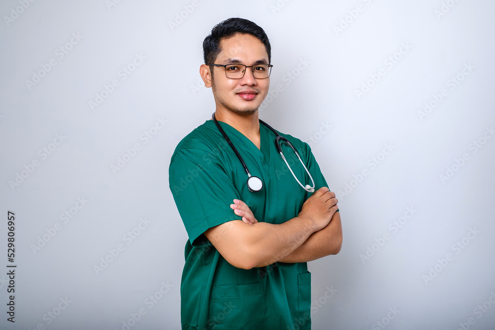 Professional good-looking asian doctor, medical worker in glasses and scrubs, cross arms and smiling Professional good-looking asian doctor, medical worker in glasses and scrubs, cross arms and smiling