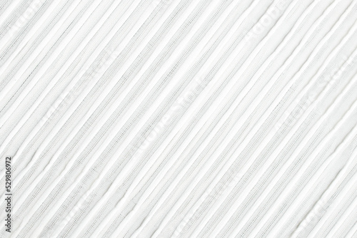 Fabric background made of tulle, a transparent mesh fabric in white with a minimalist stripe pattern