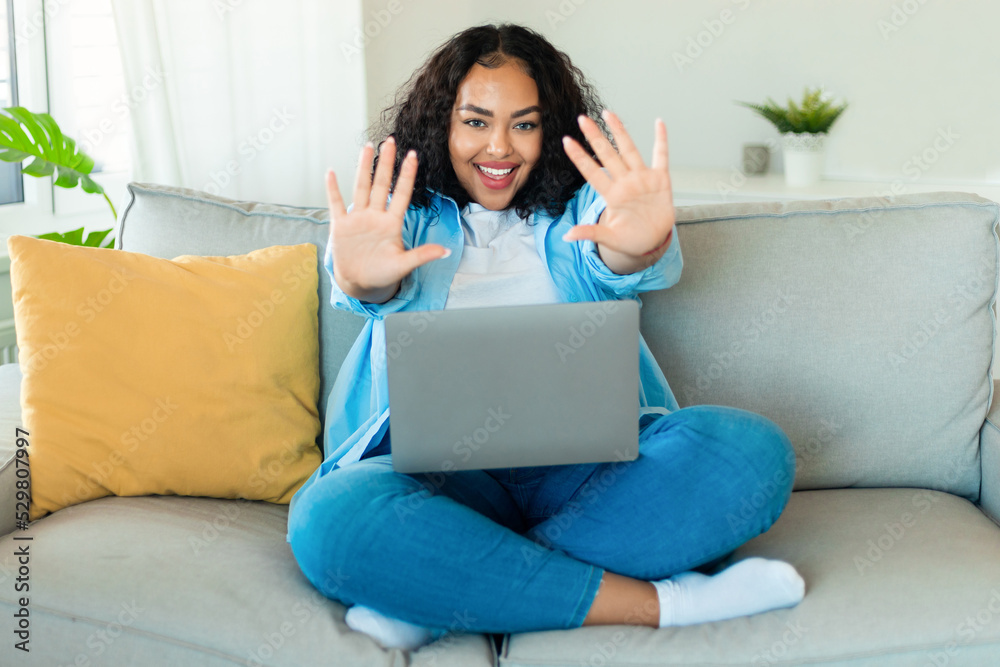 Black Woman Using Laptop Stretching Hands Waving Hello At Home Black Woman Using Laptop Stretching Hands Waving Hello At Home