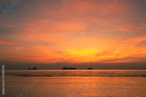 Colorful dramatic sky over the sea and islands. Reflections in the water. © mizuno555