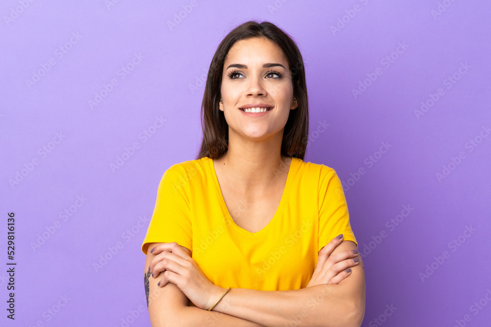 Young caucasian woman over isolated background looking up while smiling Young caucasian woman over isolated background looking up while smiling