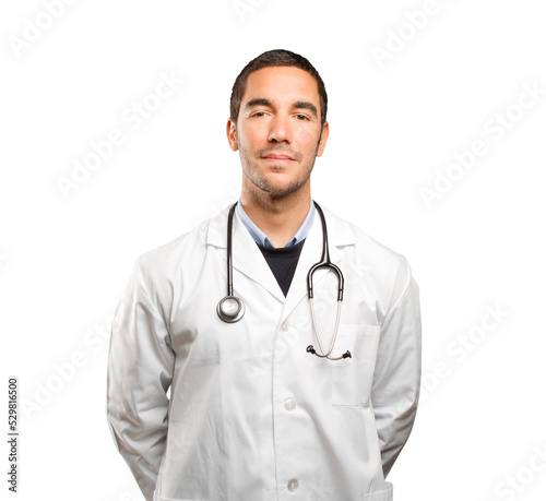 Confident doctor against white background