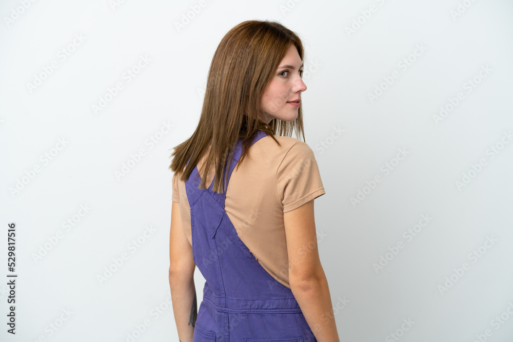Young English woman isolated on white background in back position and looking side Young English woman isolated on white background in back position and looking side
