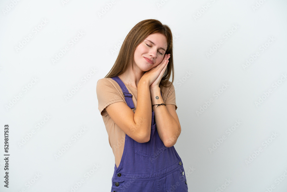 Young English woman isolated on white background making sleep gesture in dorable expression Young English woman isolated on white background making sleep gesture in dorable expression