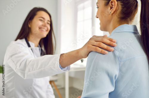 Happy patient Caucasian woman receives professional support and advice from female doctor during visit to clinic or scheduled examination by therapist in modern hospital. Selective focus