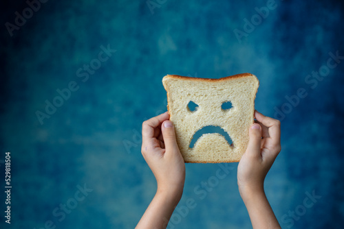 diet celiac gluten free bread in the hands of a child