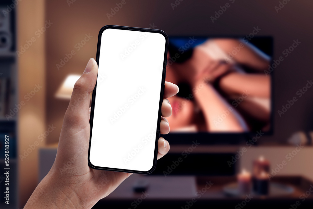 Woman watching porn on smartphone and TV