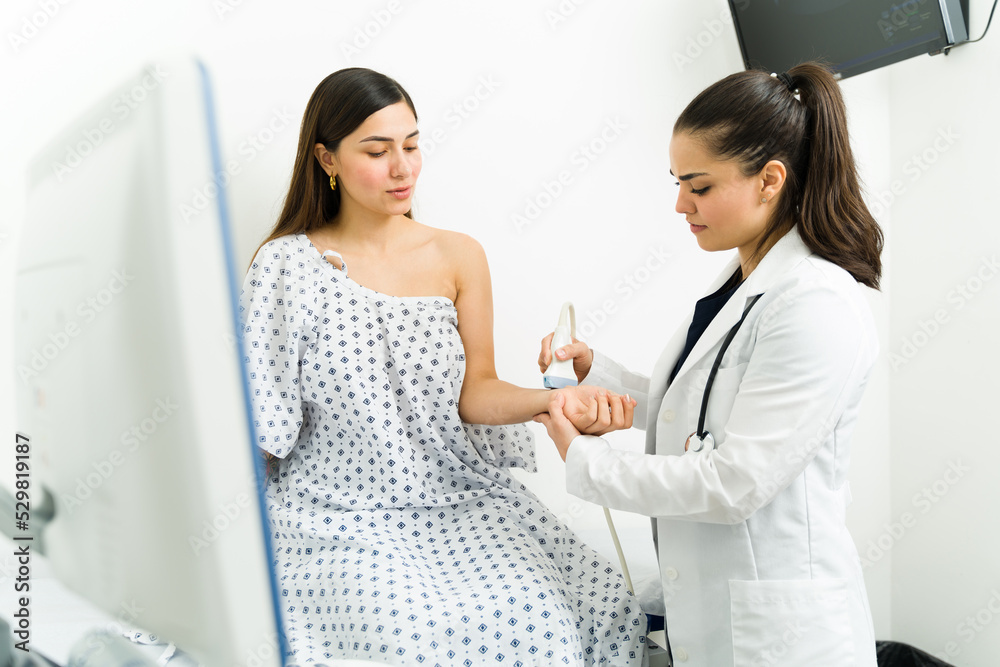 Fototapeta premium Female patient getting a ultrasound test on her wrist