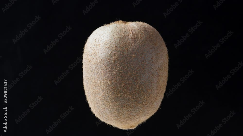 Kiwi rotates on a black background, close-up Kiwi rotates on a black background, close-up