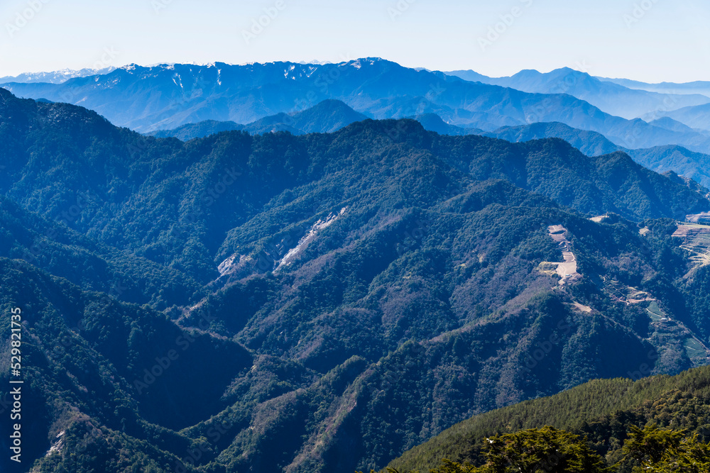 Fototapeta premium Layers of magnificent mountains and clear clouds background in the morning.