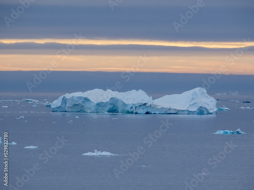 Enormous icebergs seen during the midnight sun  Disko Bay north of the Artic Circle near Ilulissat  Western Greenland