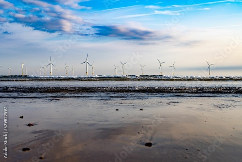 Bunch of wind turbines on a wind farm near the water in Redcar, England photo