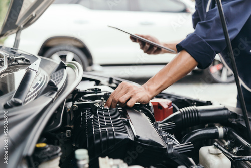 Automobile mechanic repairman hands repairing a car engine automotive workshop with a wrench, car service and maintenance,Repair service.