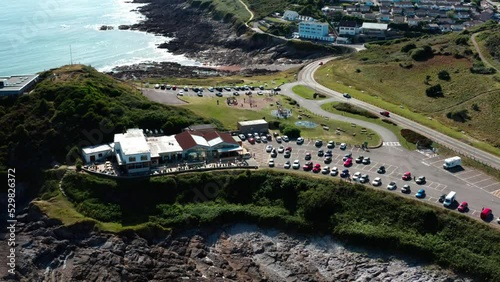 Aerial view of the mumbles Swansea bay restraunt with small town and vollage in backdrop. rasing drone shot revealing suroundings