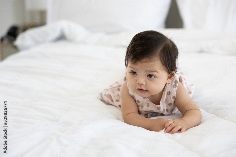 portrait cute baby crawling on bed and looking to something portrait cute baby crawling on bed and looking to something
