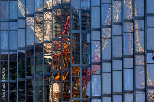 Crane reflecting in a glass facade