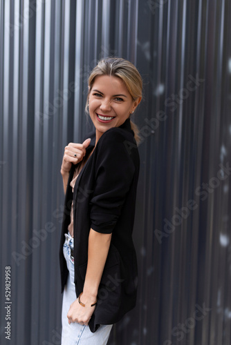 young middle-aged woman in a business suit smiling while looking at the camera