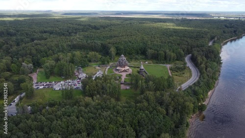 Aerial drone view of Church of the Intercession of the Holy Mother of God in the Bogoslovka estate near the Neva river at suburb of city Saint-Petersburg at sunset 4k footage