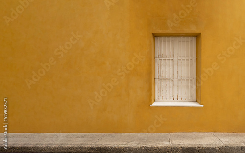White window on panoramic yellow wall background.