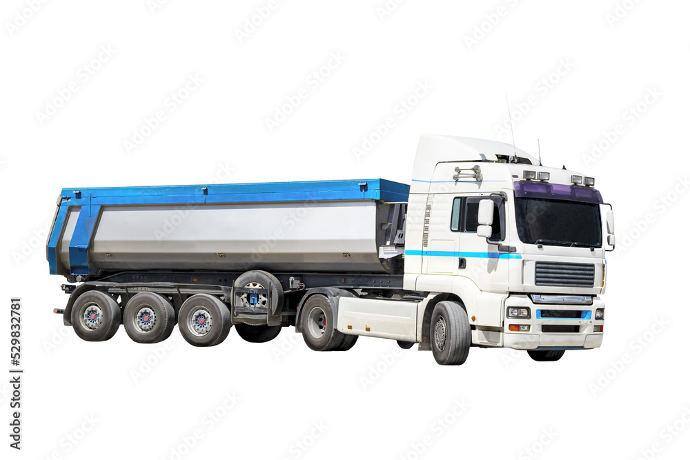 A large dump truck unloads rubble or gravel at a construction site. Car tonar for transportation of heavy bulk cargo. Dump truck isolated on white background.