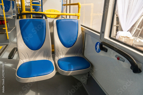 New comfortable seats inside a modern public bus. Seats on the bus for the elderly, people with disabilities and passengers with children. Special seats for certain categories of passengers.