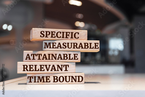 Wooden blocks with words 'Specific, Measurable, Attainable, Relevant, Time bound'. SMART