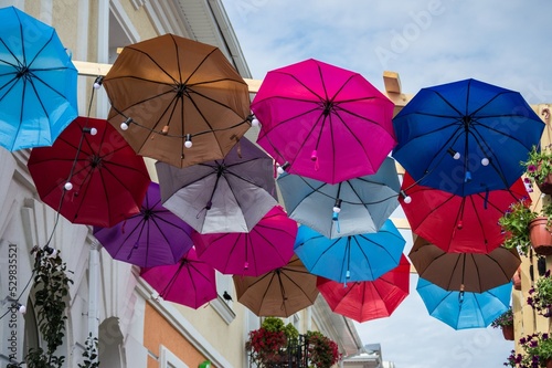 Rows of colorful umbrellas floating in air