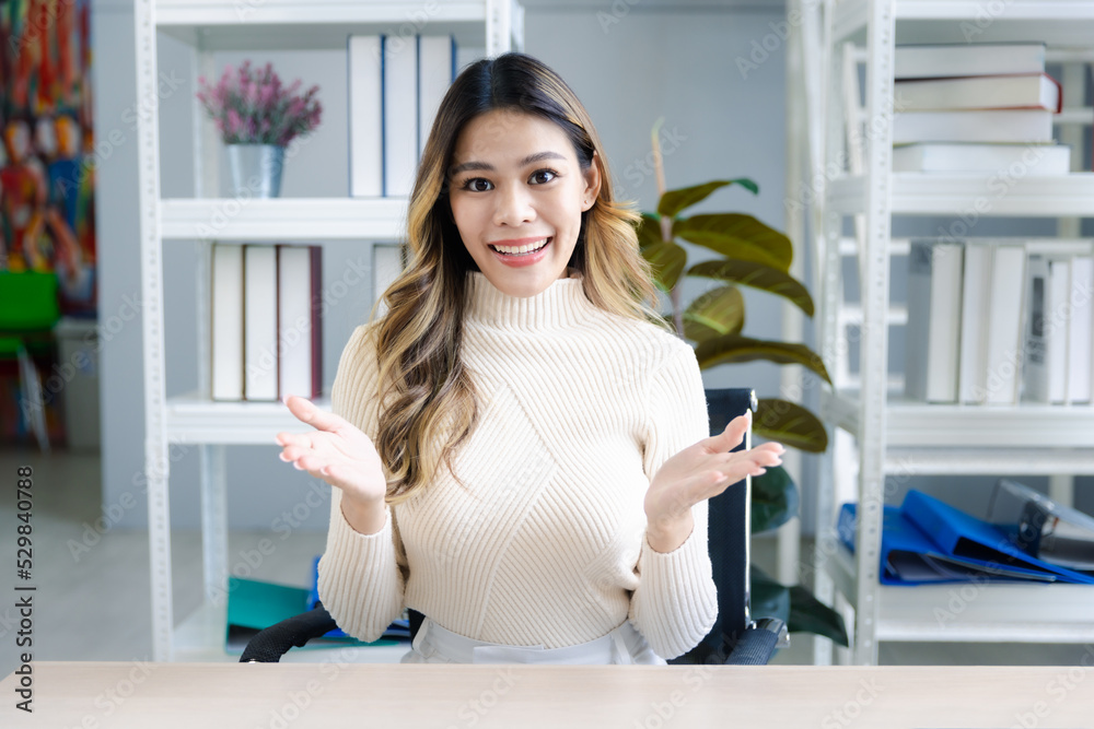 Portrait of attractive young asian female in casual clothing posing smile, speaking, talking in video call meeting, Looking at camera Portrait of attractive young asian female in casual clothing posing smile, speaking, talking in video call meeting, Looking at camera