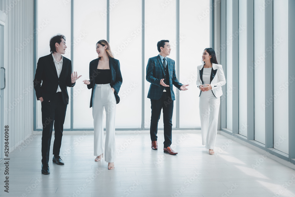 Group business people in formal wear walking standing discussion in modern office Group business people in formal wear walking standing discussion in modern office