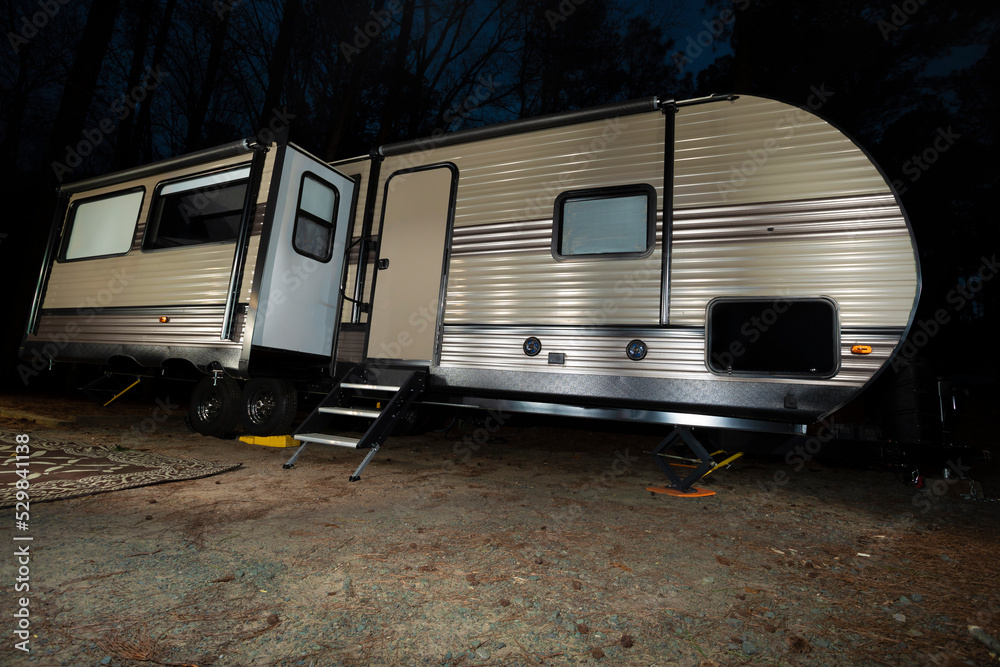 Long camping trailer at night