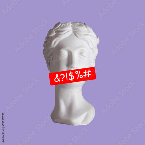 Female antique statue's head with line of swearing speech censored with symbols on her mouth isolated on purple background. Trendy collage in magazine style. Contemporary art. Modern design photo