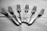 Forks arranged on a crumpled white paper tablecloth