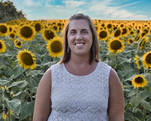 Woman Standing in Large Sunflower Field in Kansas photo