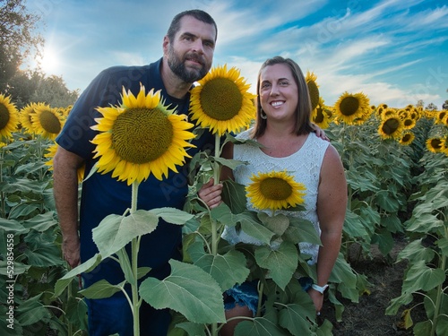 Man and Woman Posing in Kansas Sunflower Field photo